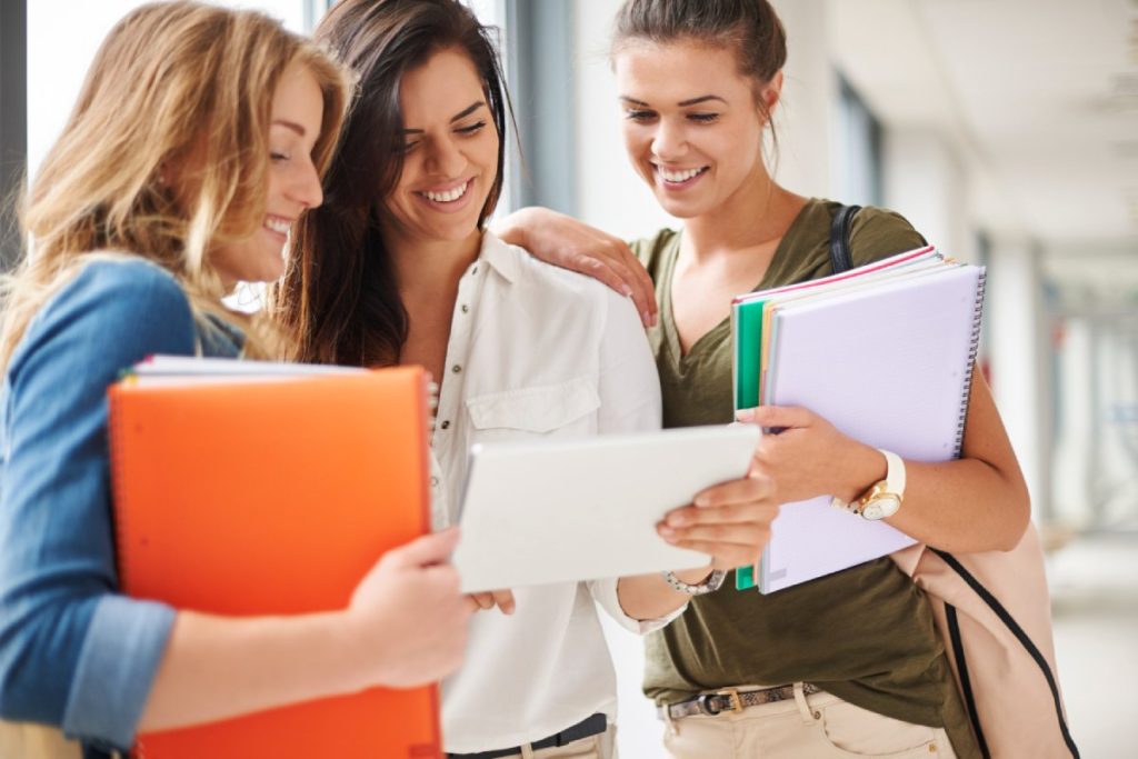 Estudiantes leyendo los requisitos para solicitar las becas del INAP